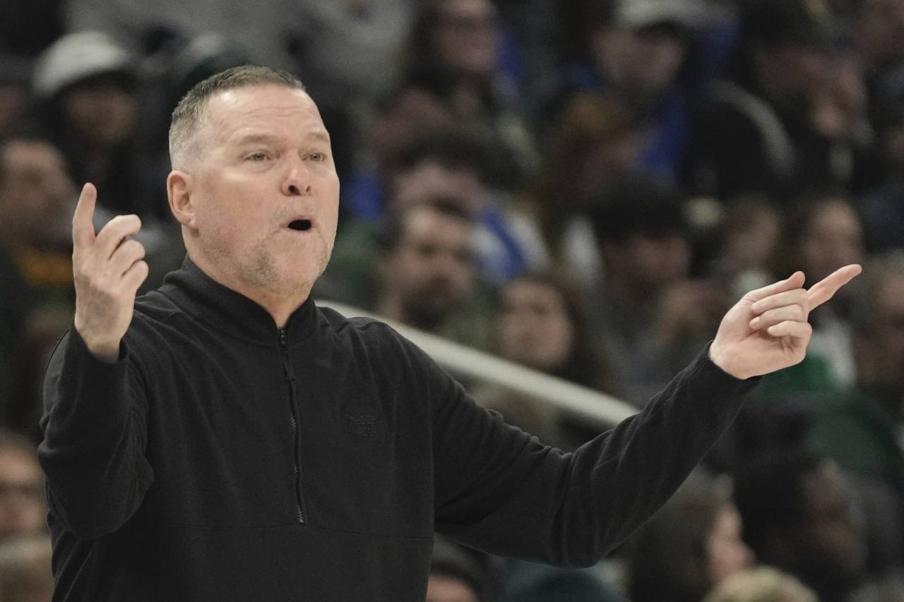 Denver Nuggets head coach Michael Malone reacts during the first half of an NBA basketball game Wed...