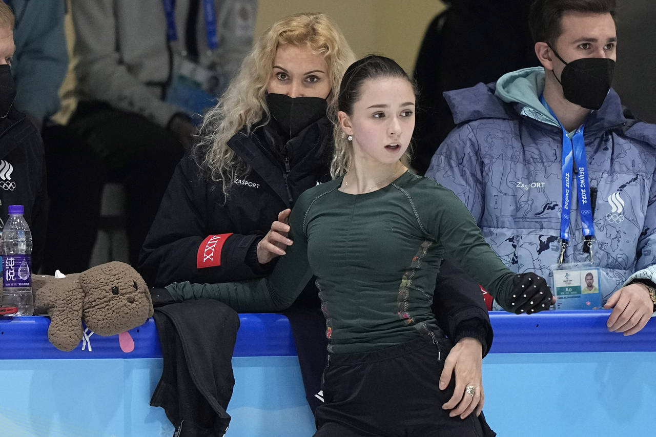 FILE - Coach Eteri Tutberidze, left, talks to Kamila Valieva, center, of the Russian Olympic Commit...