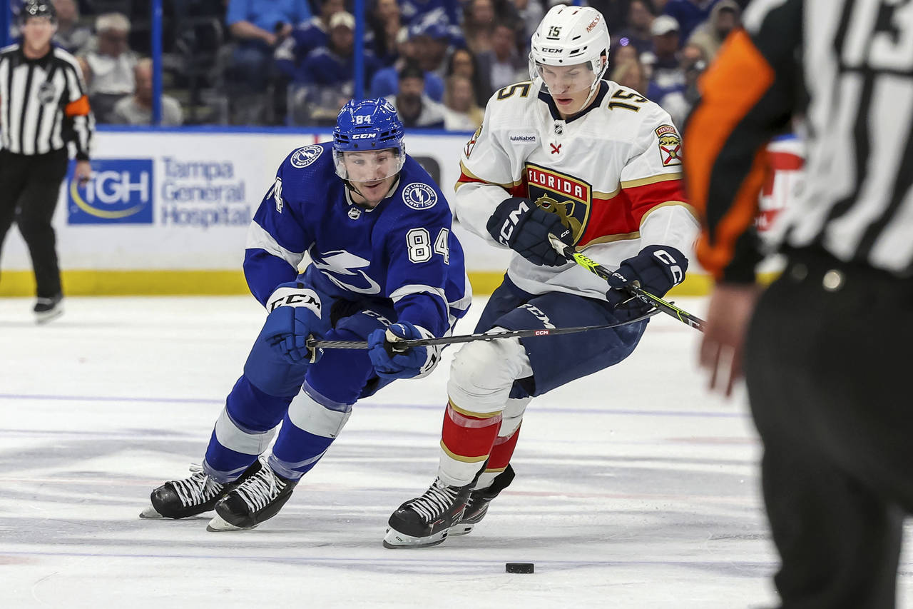 Tampa Bay Lightning's Tanner Jeannot and Florida Panthers' Anton Lundell compete for the puck durin...