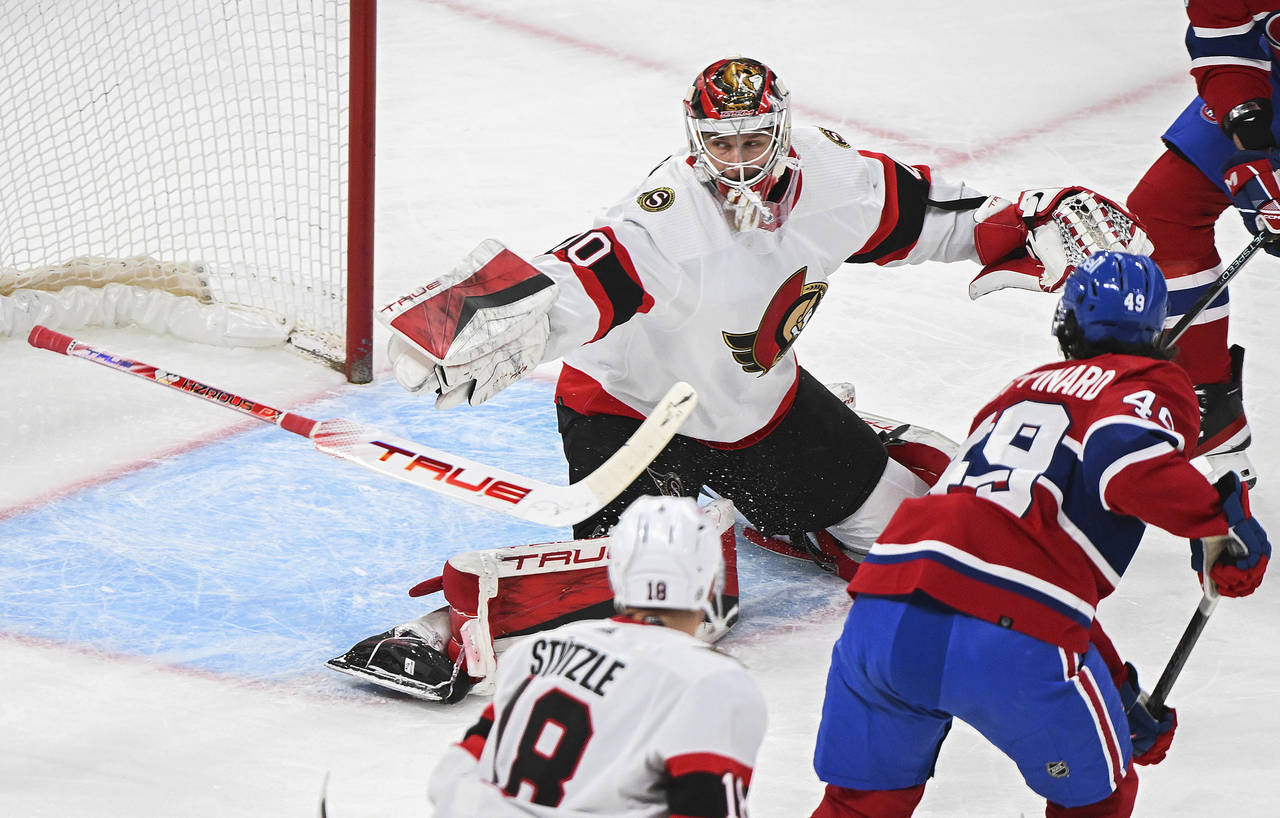 Ottawa Senators goaltender Mads Sogaard (40) loses his stick as Montreal Canadiens' Rafael Harvey-P...