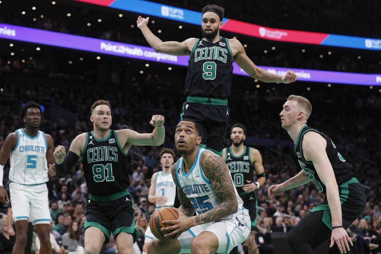 Charlotte Hornets' P.J. Washington (25) looks to shoot as Boston Celtics' Derrick White (9), Blake ...