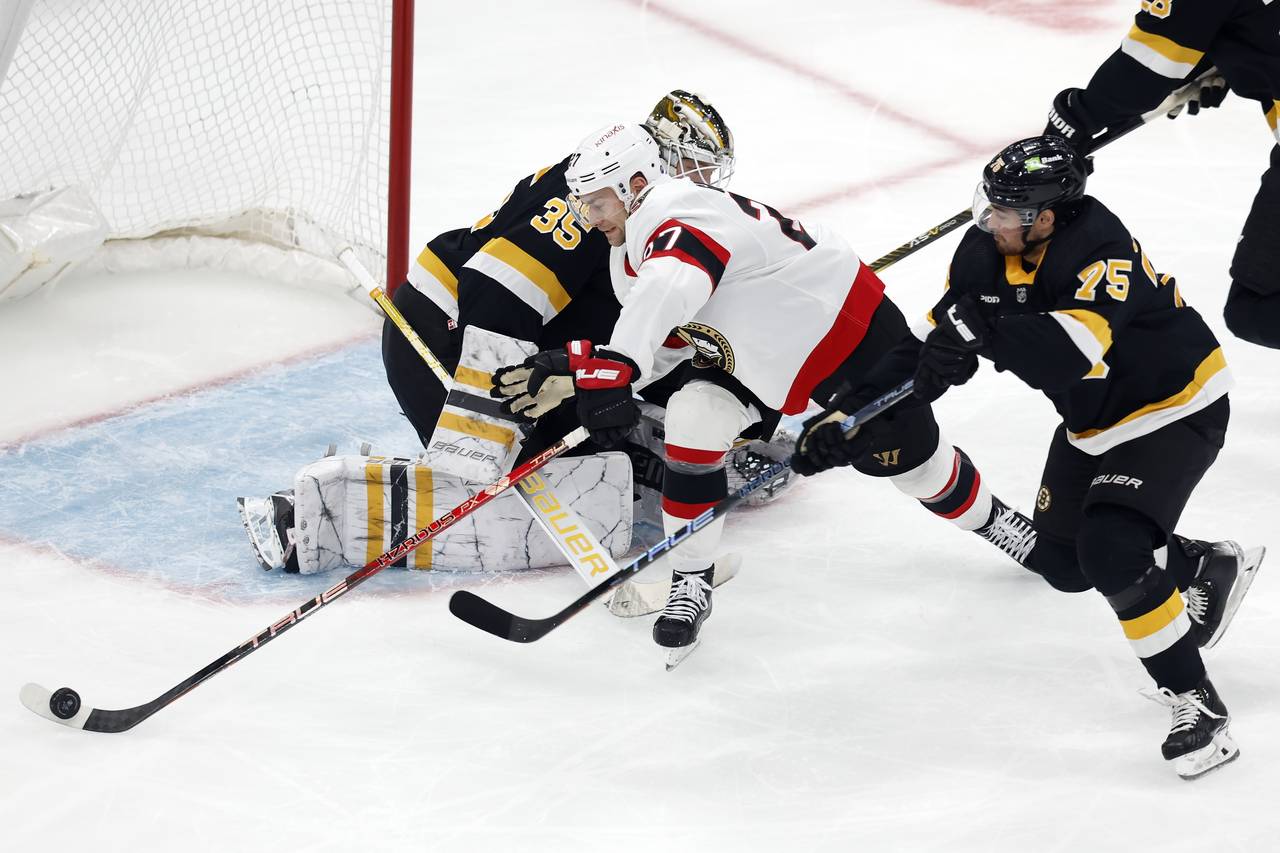 Ottawa Senators' Dylan Gambrell (27) tries to control the puck against Boston Bruins goaltender Lin...