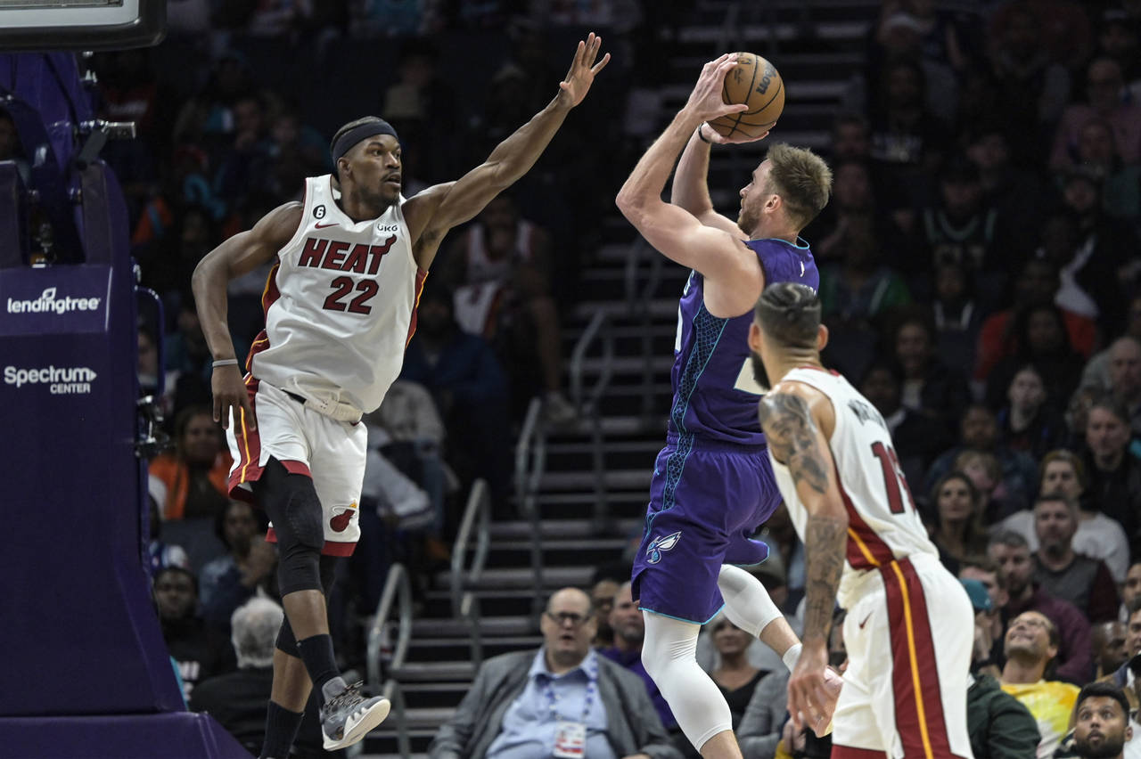 Miami Heat forward Jimmy Butler (22) attempts to block a shot from Charlotte Hornets forward Gordon...