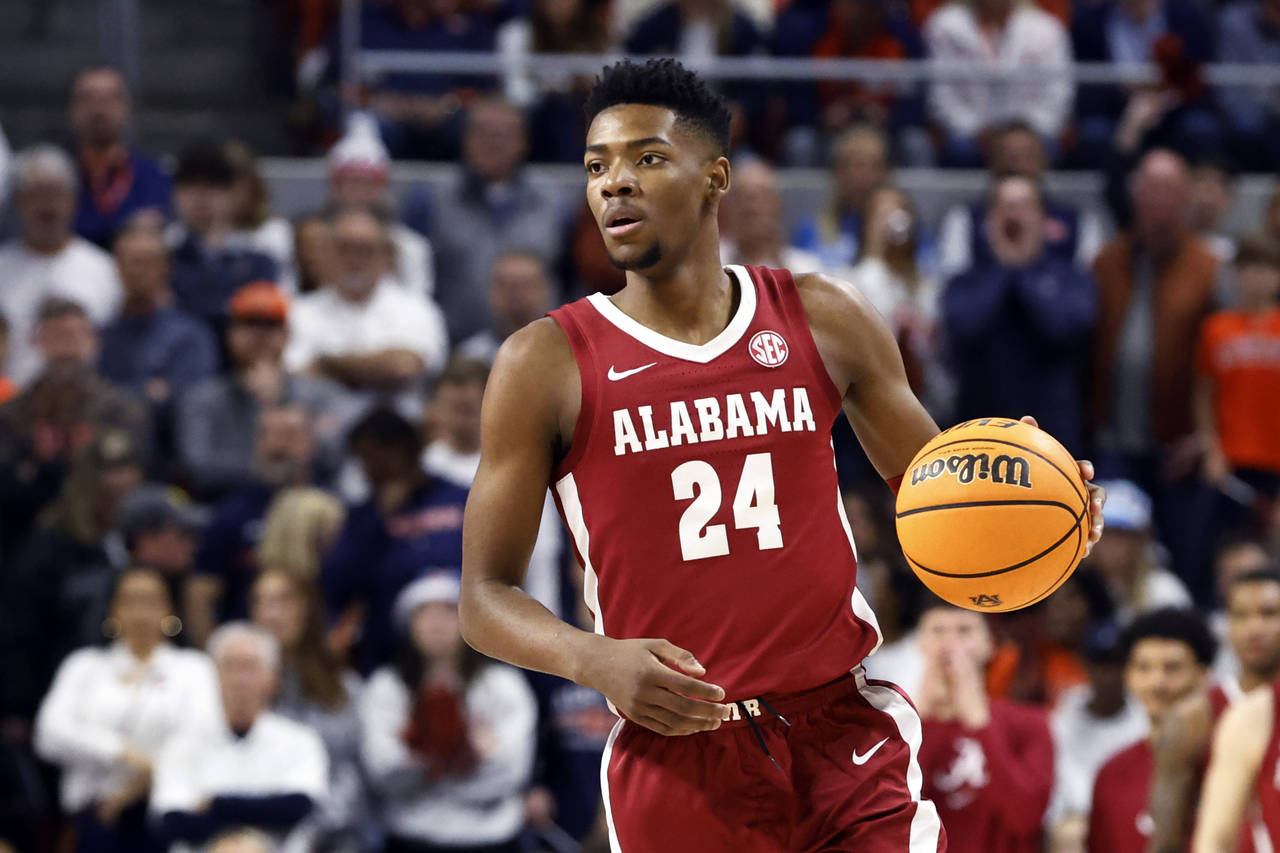 FILE - Alabama forward Brandon Miller brings the ball up during the first half of the team's NCAA c...