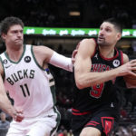 Giannis sets assists mark, hurts wrist; Bucks beat Bulls