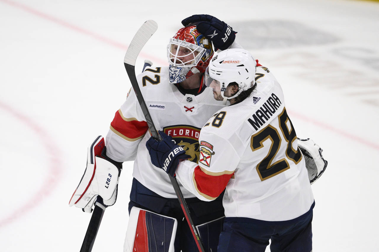 Florida Panthers goaltender Sergei Bobrovsky (72) and defenseman Josh Mahura (28) celebrate after t...