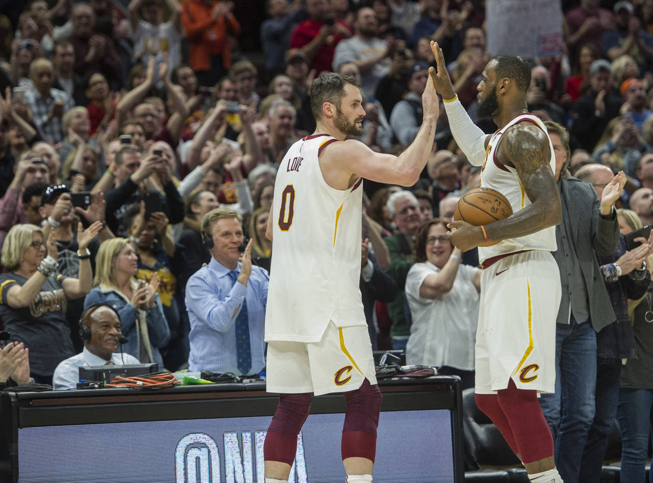 FILE - Cleveland Cavaliers' LeBron James, right, is congratulated by Kevin Love, after Jame's 867th...