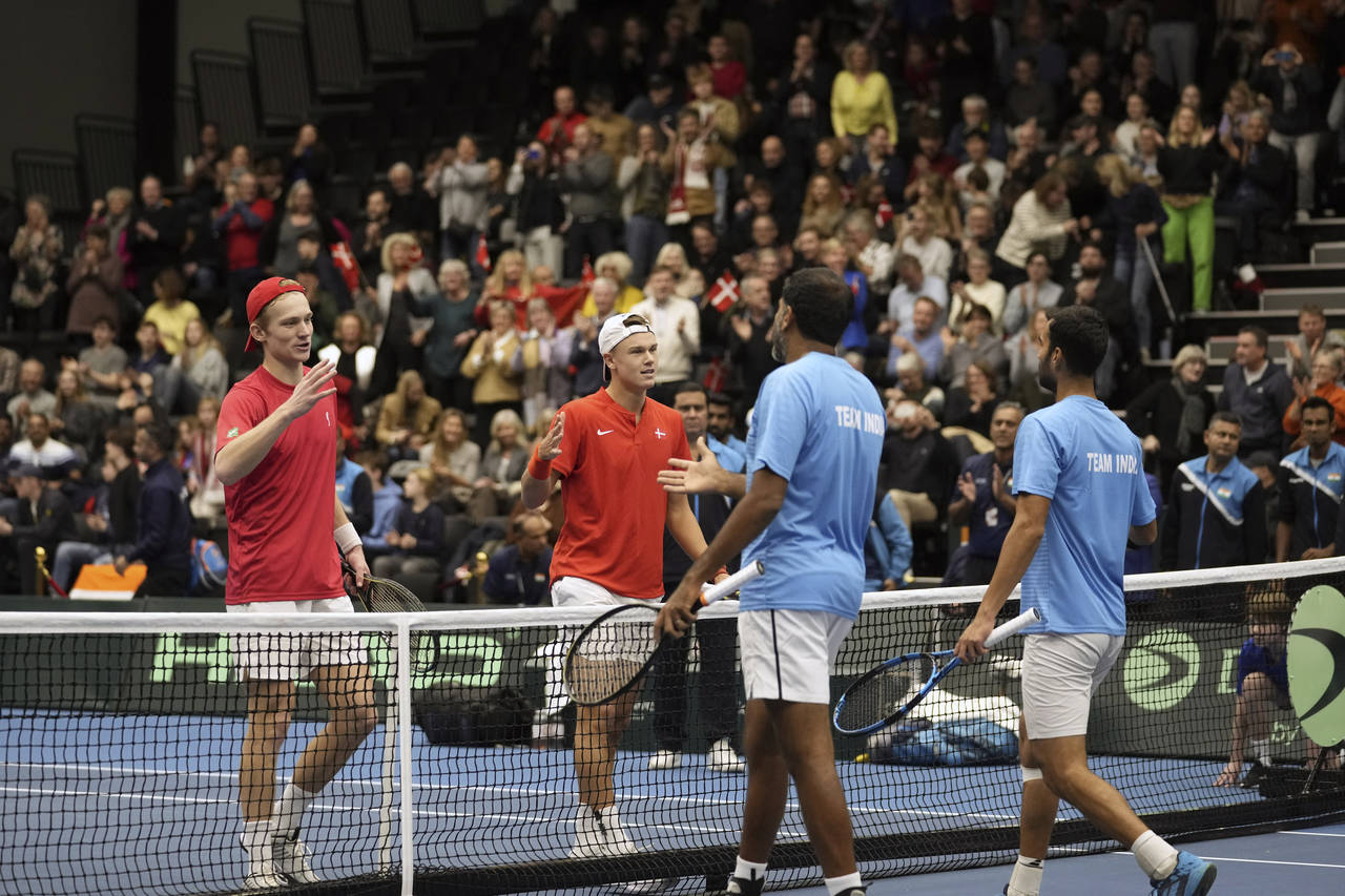 Johannes Ingildsen, left, and Holger Rune, second left, of Denmark greet rivals Yuki Bhambri, right...