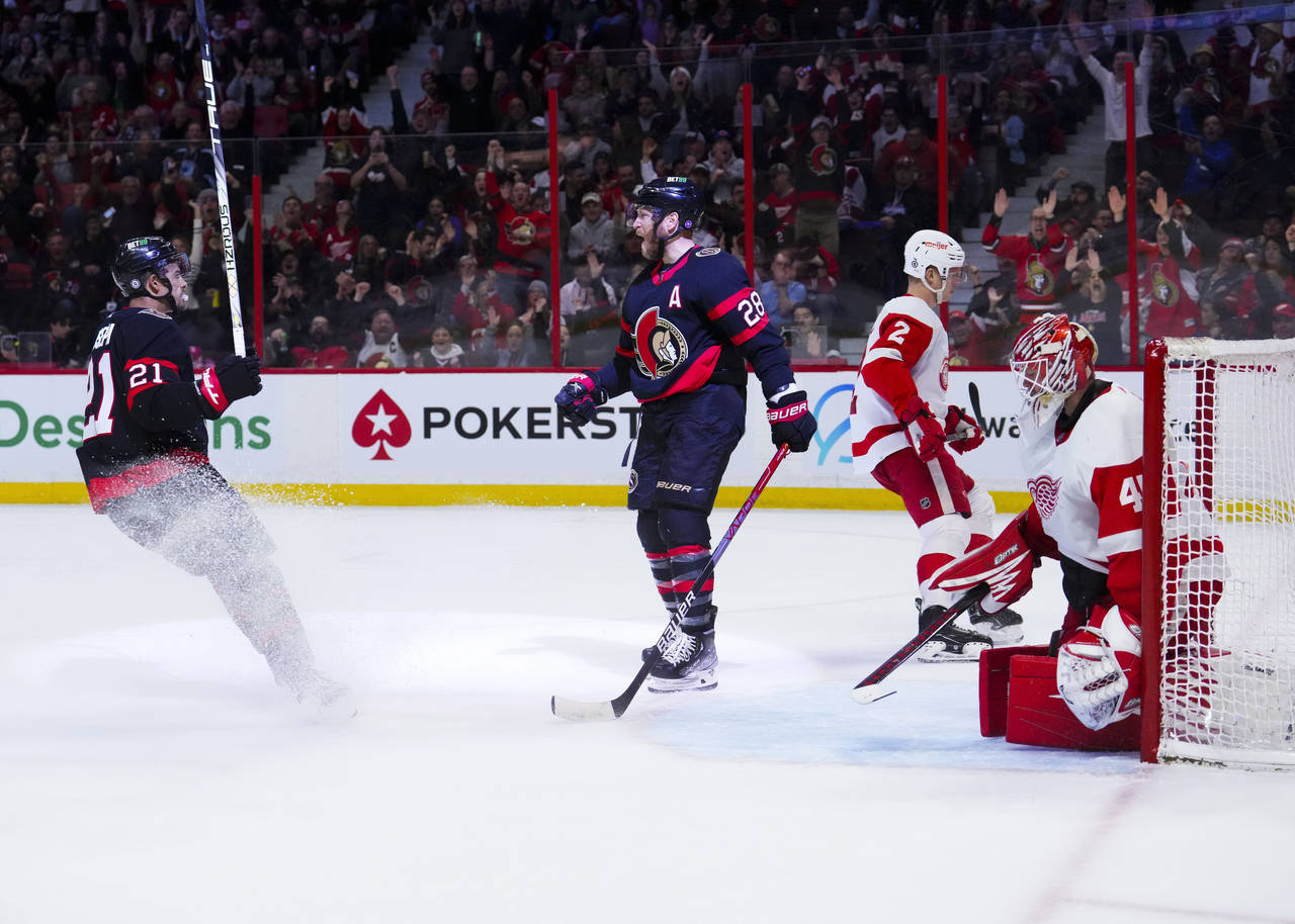 Ottawa Senators right wing Claude Giroux (28) celebrates teammate Mathieu Joseph (21) after his goa...