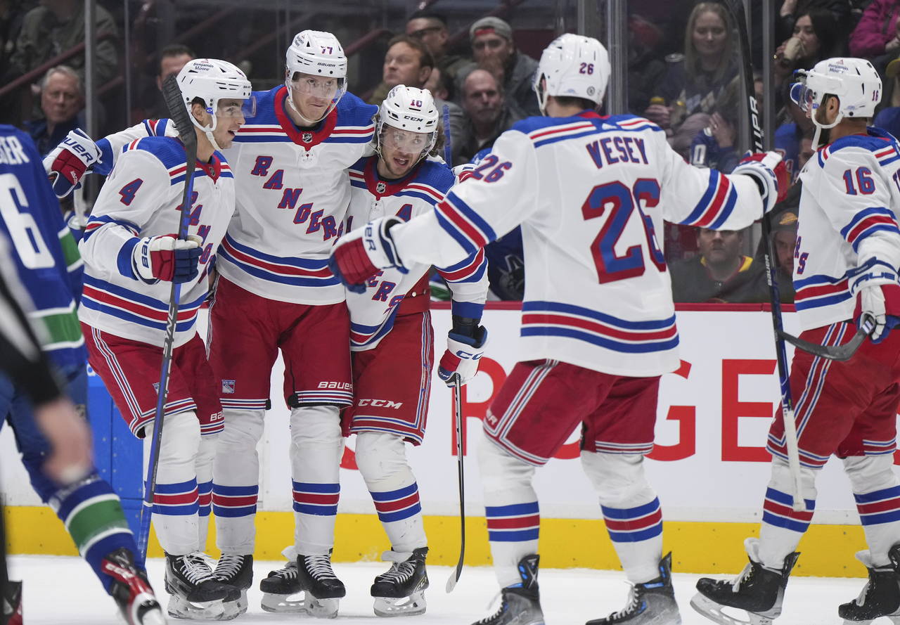 New York Rangers' Braden Schneider, Niko Mikkola, Artemi Panarin, Jimmy Vesey and Vincent Trocheck,...