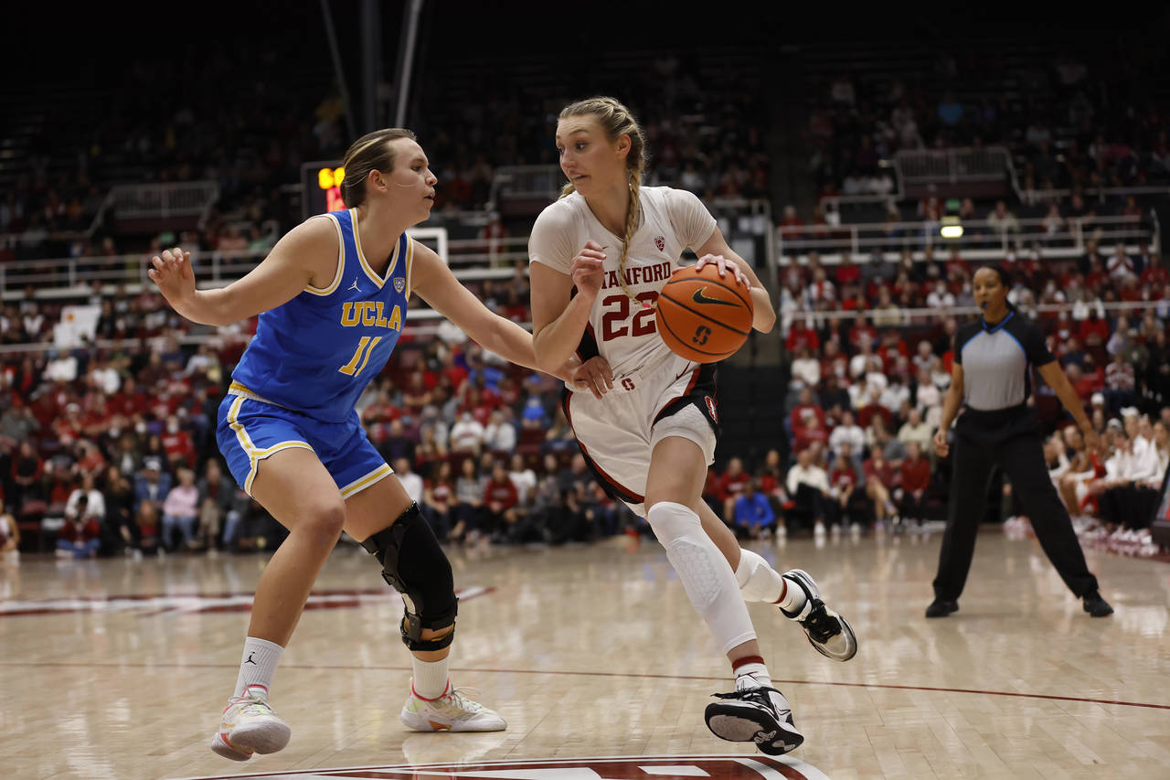 Stanford forward Cameron Brink (22) drives to the basket against UCLA forward Emily Bessoir (11) du...
