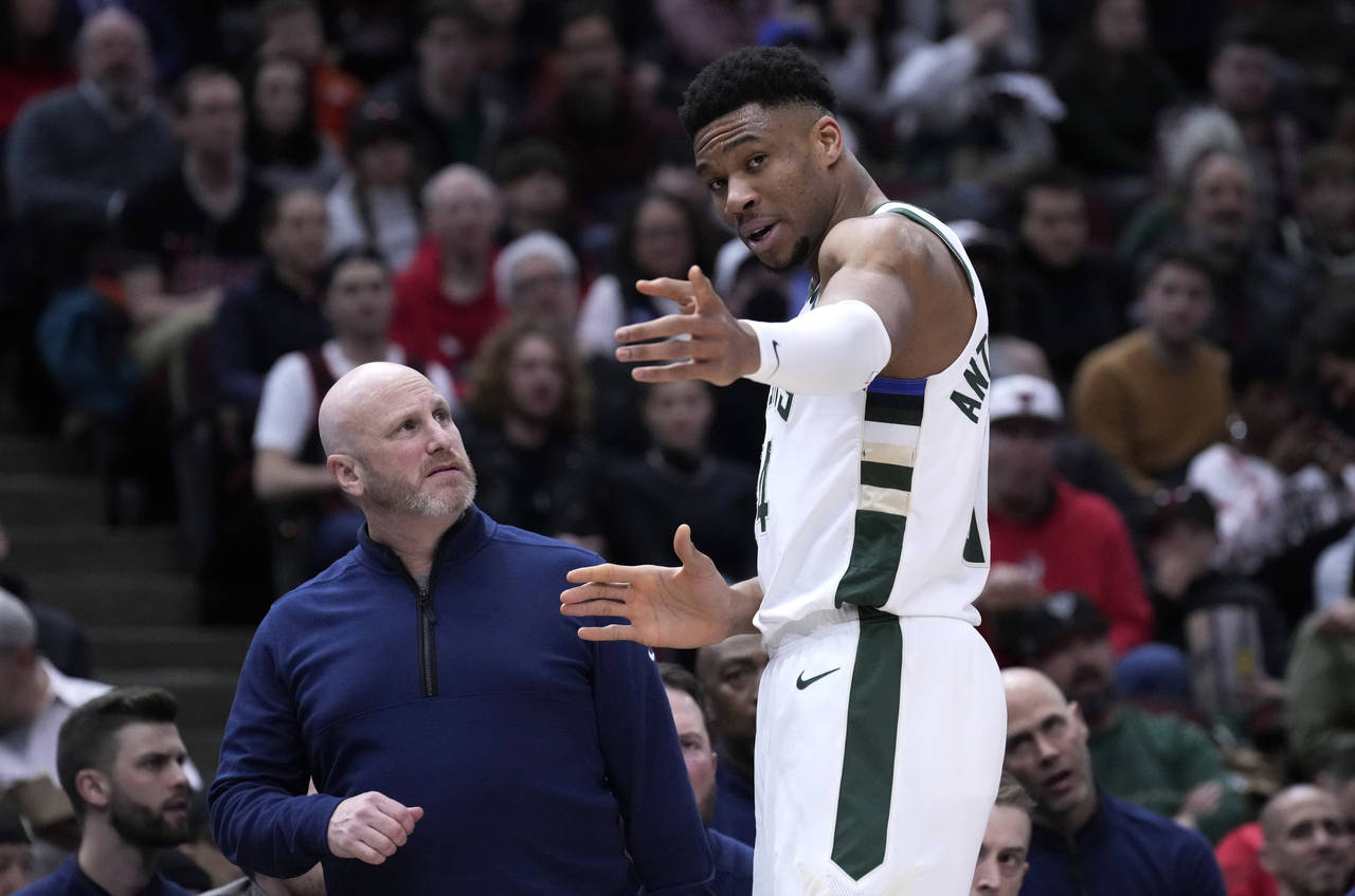 Milwaukee Bucks' Giannis Antetokounmpo points to where he injured his right hand, while talking to ...