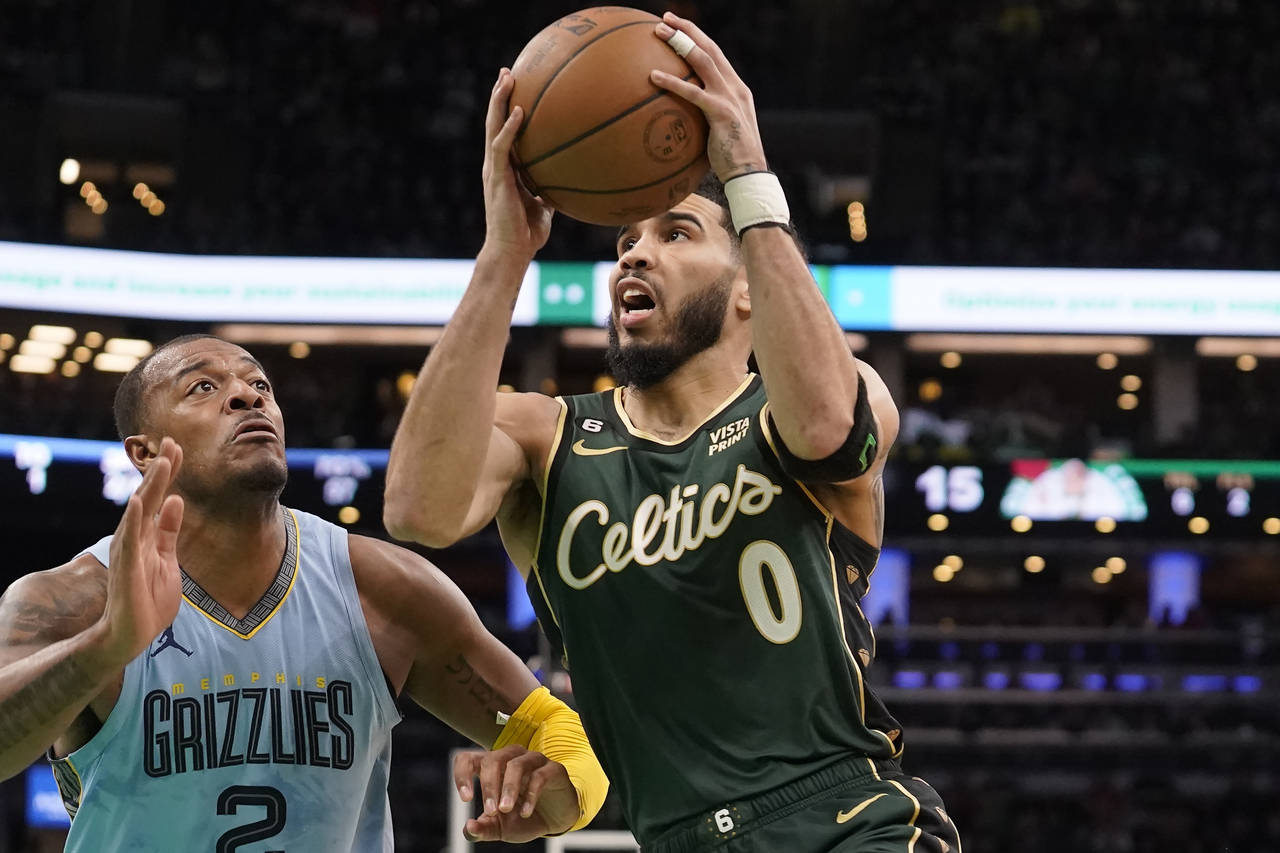 Boston Celtics forward Jayson Tatum (0) drives toward the basket as Memphis Grizzlies forward Xavie...