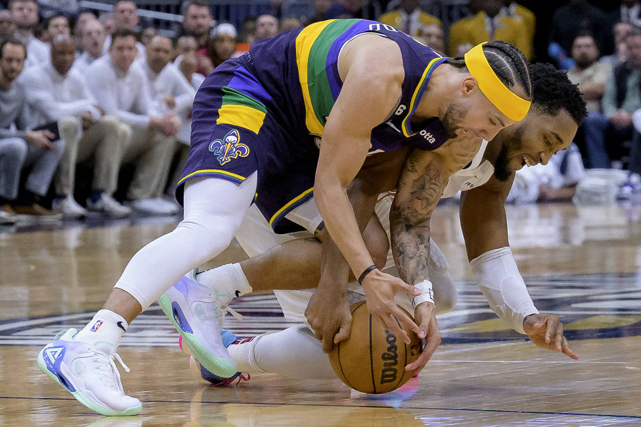 New Orleans Pelicans guard Jose Alvarado, left, and Cleveland Cavaliers guard Donovan Mitchell vie ...