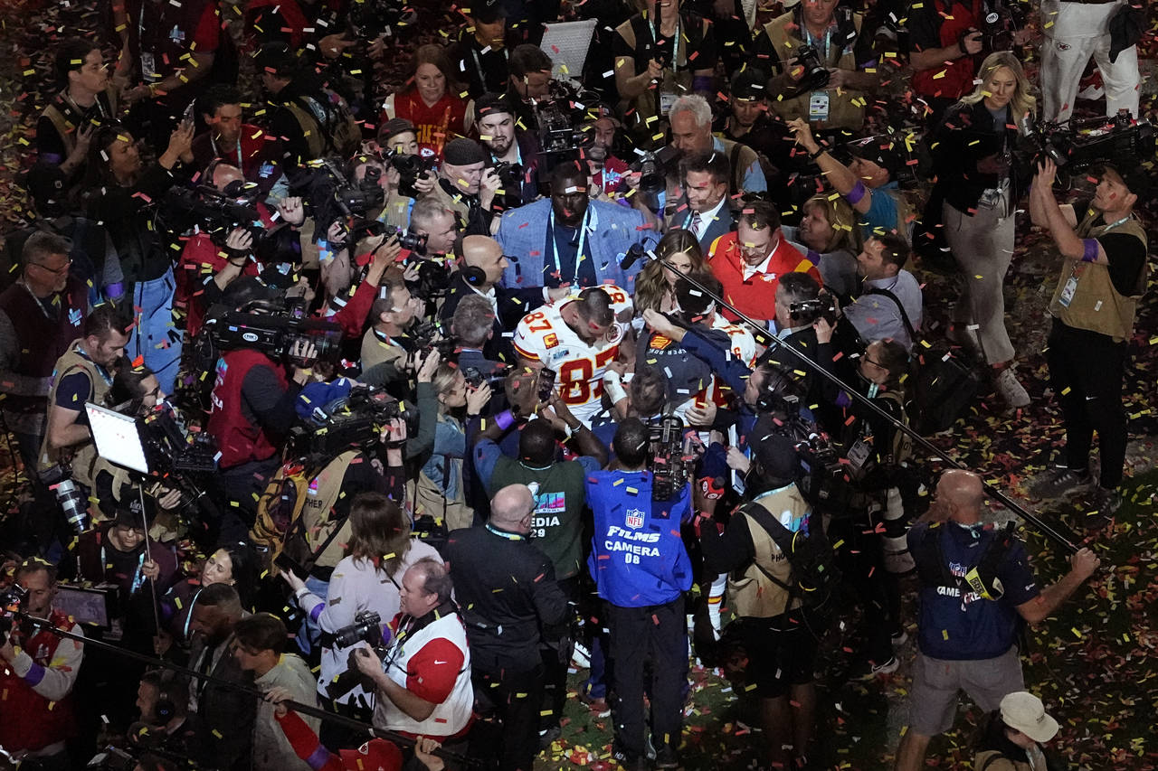 Kansas City Chiefs tight end Travis Kelce (87) is surrounded after the NFL Super Bowl 57 football g...