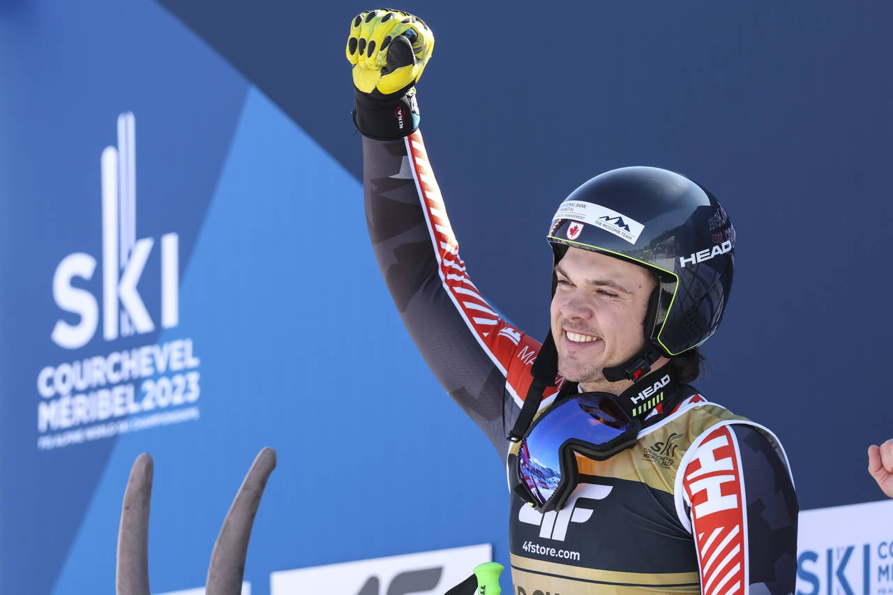 Canada's James Crawford celebrates winning an alpine ski, men's World Championship super-G race, in...