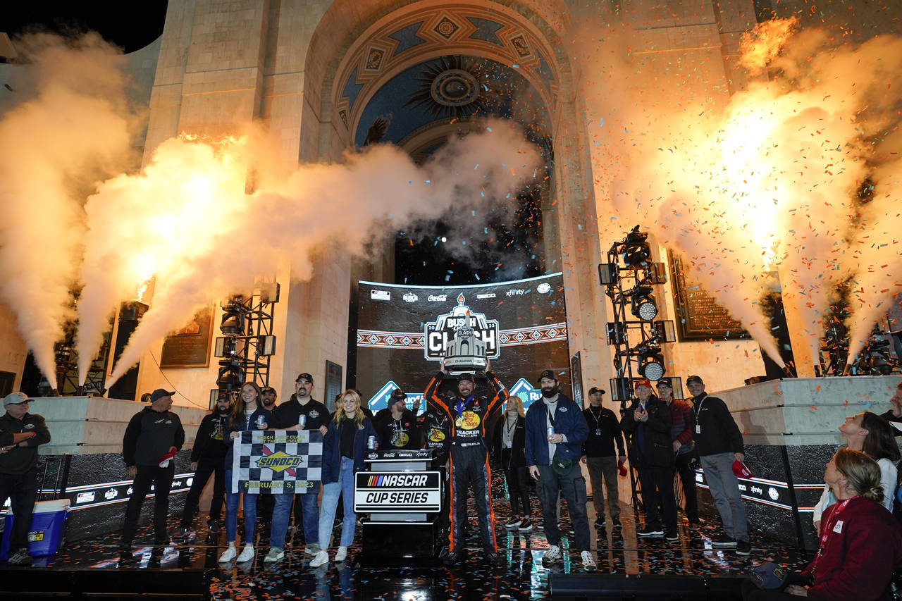 NASCAR Cup Series driver Martin Truex Jr. (19) poses for a photo with the championship trophy after...