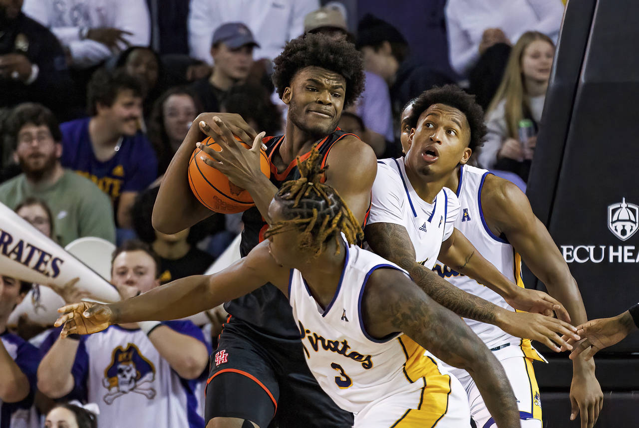 Houston's Jarace Walker tries to keep the ball from East Carolina's RJ Felton (3) and Brandon Johns...