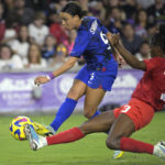 US women beat Canada 2-0, show support in labor dispute