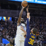 Curry injures left leg leading Warriors over Mavs 119-113