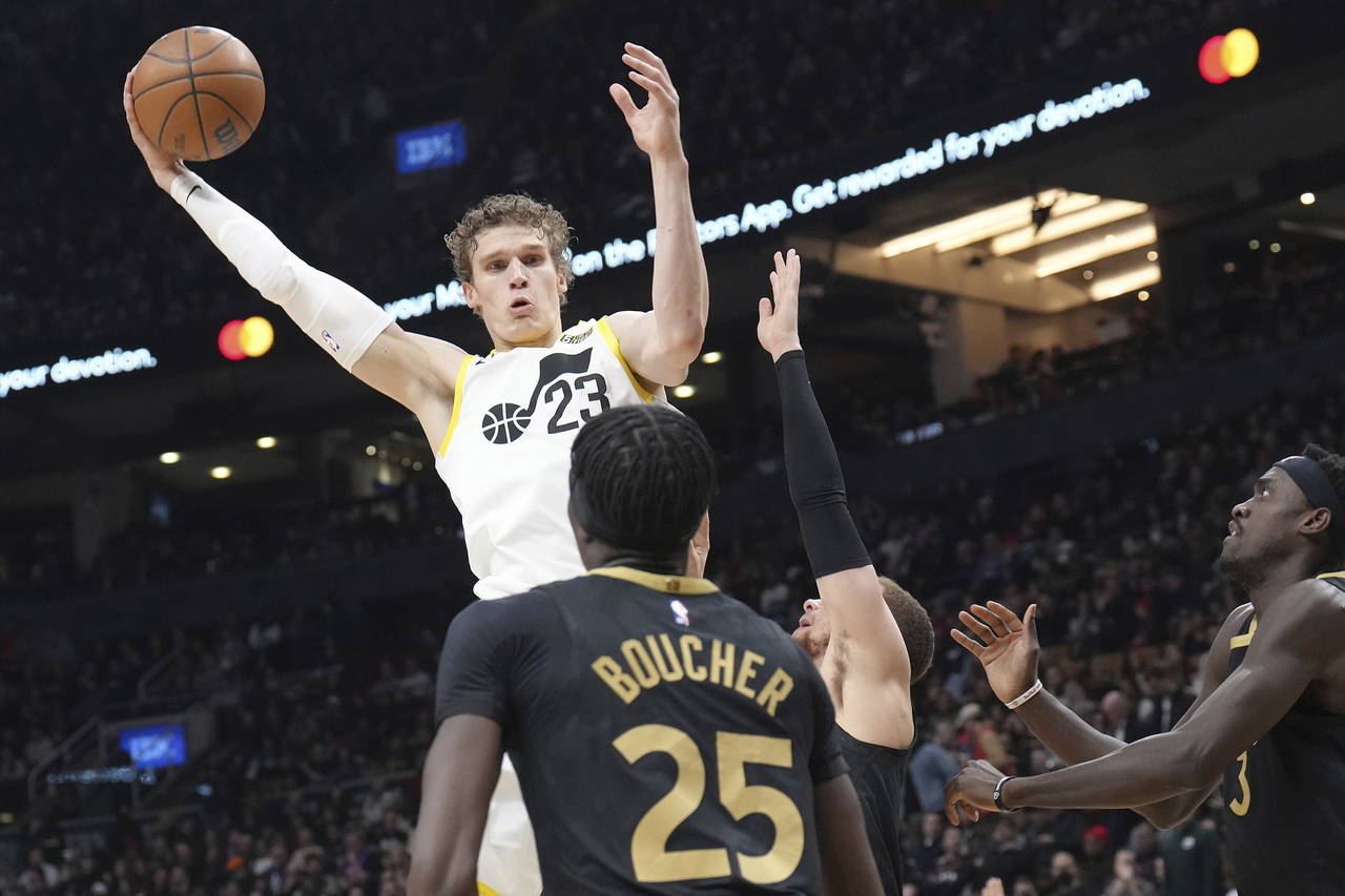 Utah Jazz's Lauri Markkanen (23) is defended by Toronto Raptors' Chris Boucher and Pascal Siakam, r...