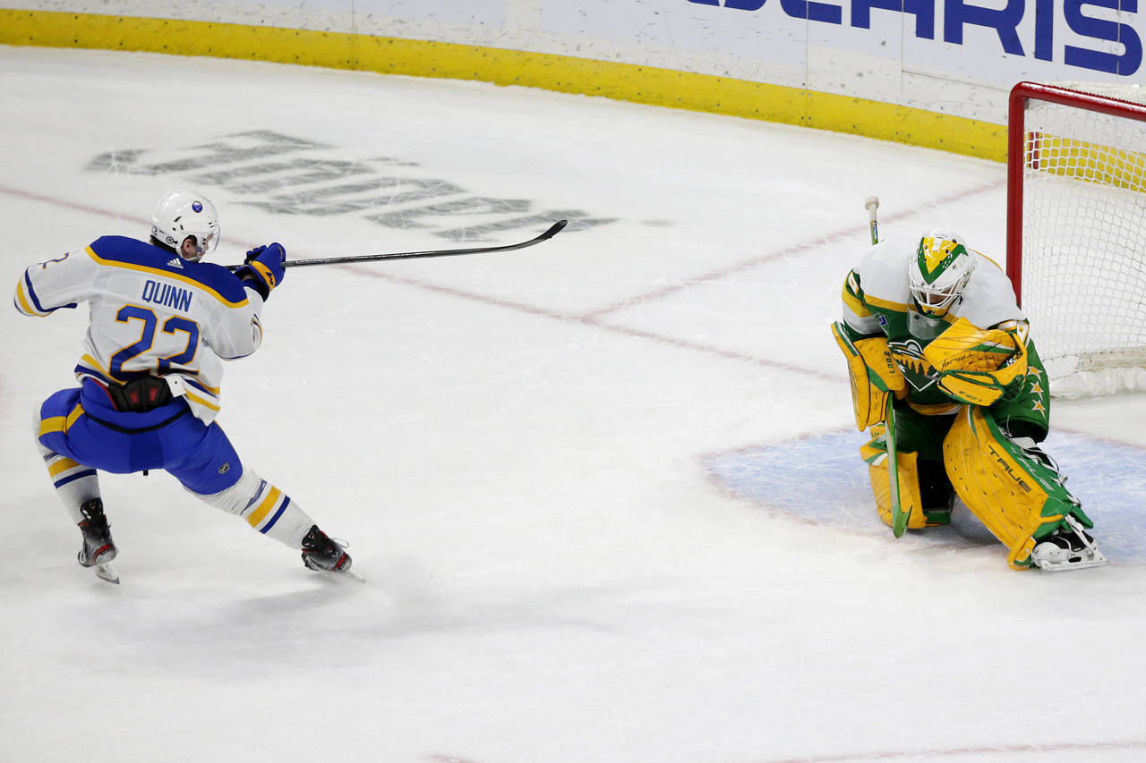 Minnesota Wild goaltender Marc-Andre Fleury, right, stops a shot by Buffalo Sabres right wing Jack ...