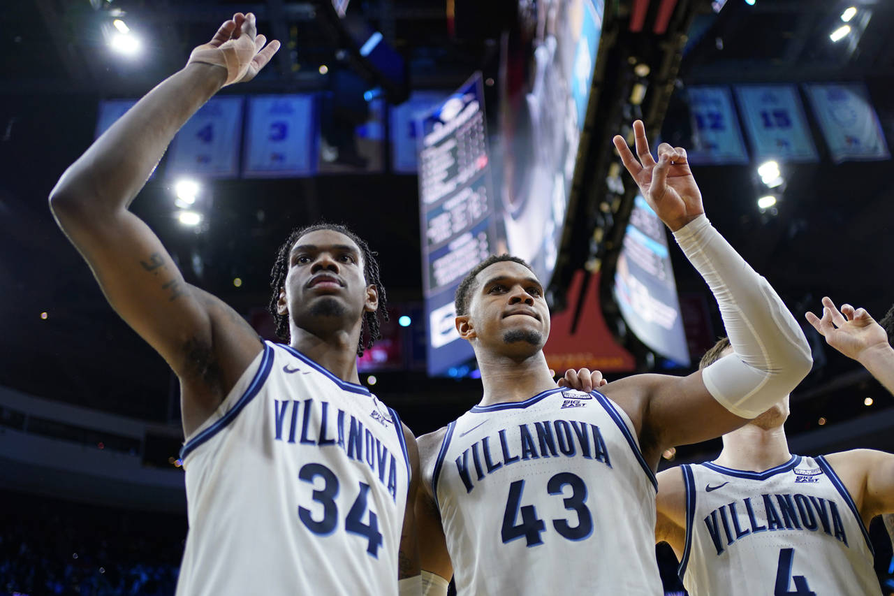 Villanova's Eric Dixon (43) and Brandon Slater (34) celebrate after an NCAA college basketball game...