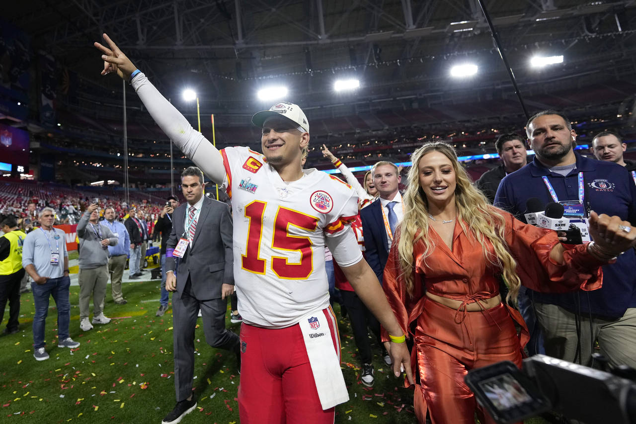 Kansas City Chiefs quarterback Patrick Mahomes (15) leaves the field with his wife, Brittany, after...
