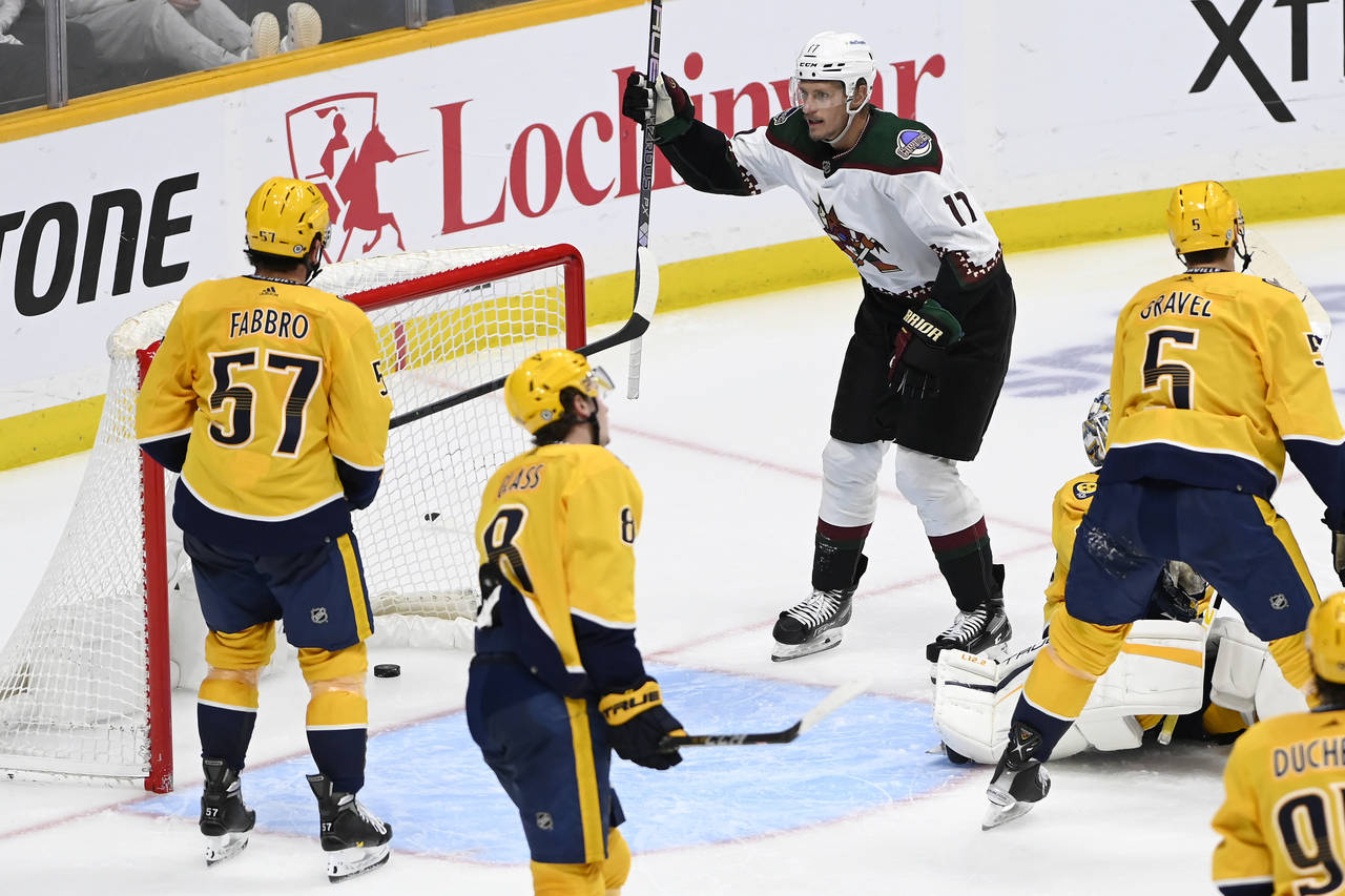 Arizona Coyotes center Nick Bjugstad (17) celebrates after a goal by teammate Lawson Crouse (not sh...