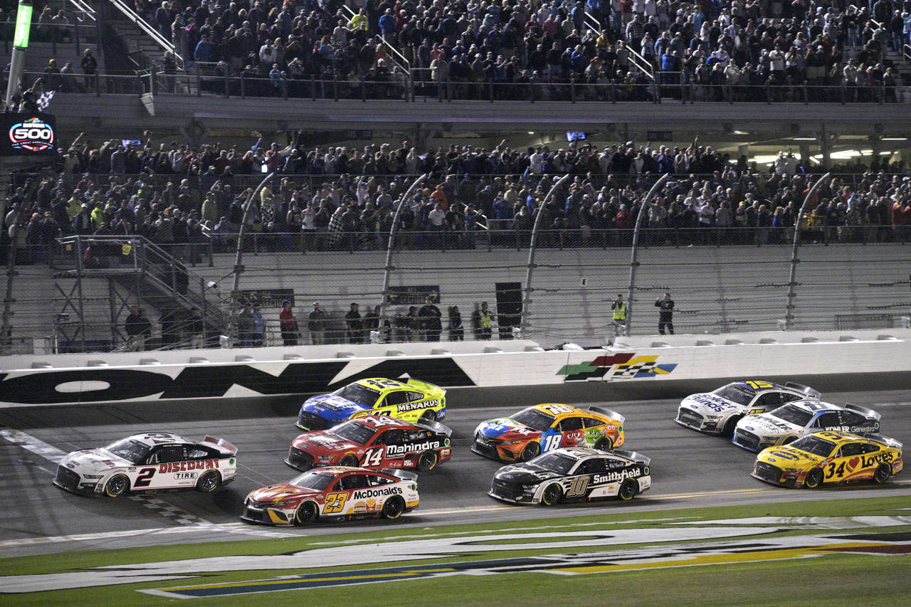 FILE - Austin Cindric (2) takes the checkered flag in front of Bubba Wallace (23) to win the NASCAR...