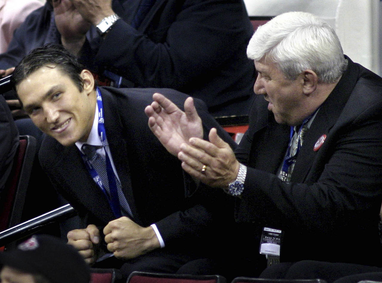 FILE - Alex Ovechkin, left, of Russia, reacts after being selected as the first overall pick by the...