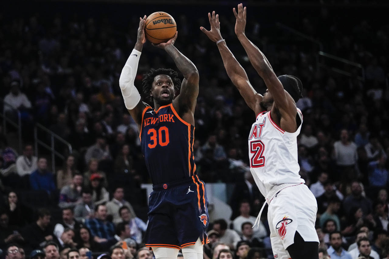 New York Knicks' Julius Randle, left, shoots over Miami Heat's Jimmy Butler during the second half ...