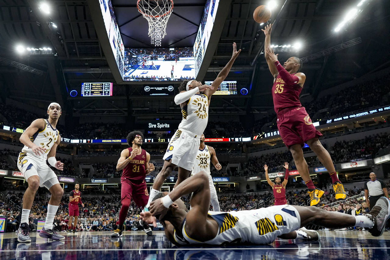 Cleveland Cavaliers forward Isaac Okoro (35) shoots over Indiana Pacers guard Buddy Hield (24) duri...