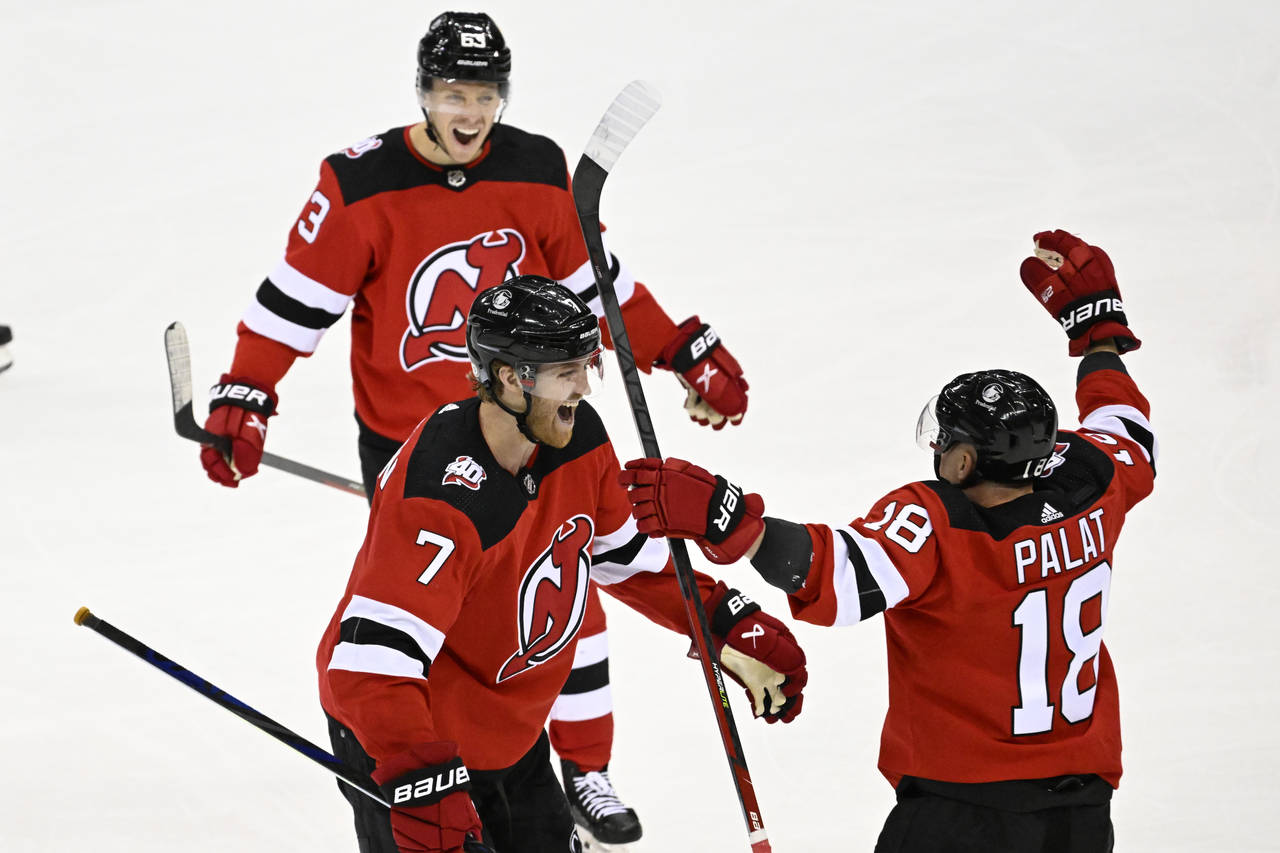 New Jersey Devils defenseman Dougie Hamilton (7) celebrates after his goal with Ondrej Palat (18) a...
