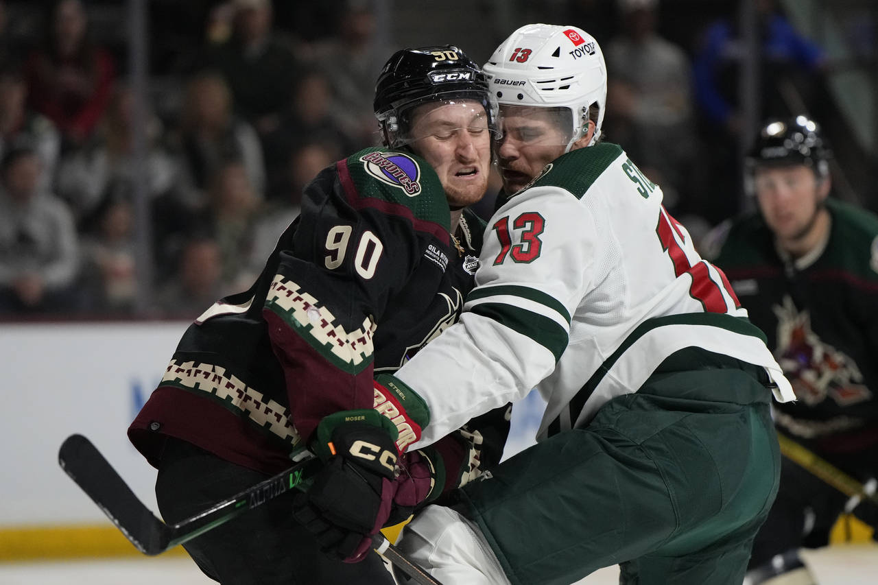 Arizona Coyotes defenseman J.J. Moser (90) and Minnesota Wild center Sam Steel collide in the secon...