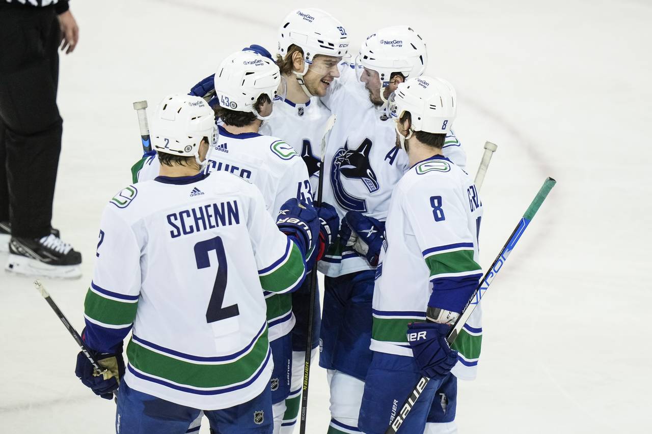 Vancouver Canucks' Vasily Podkolzin (92) celebrates with teammates after scoring a goal during the ...