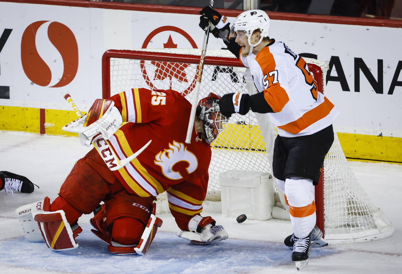 Philadelphia Flyers forward Wade Allison, right, celebrates after his goal as Calgary Flames goalie...
