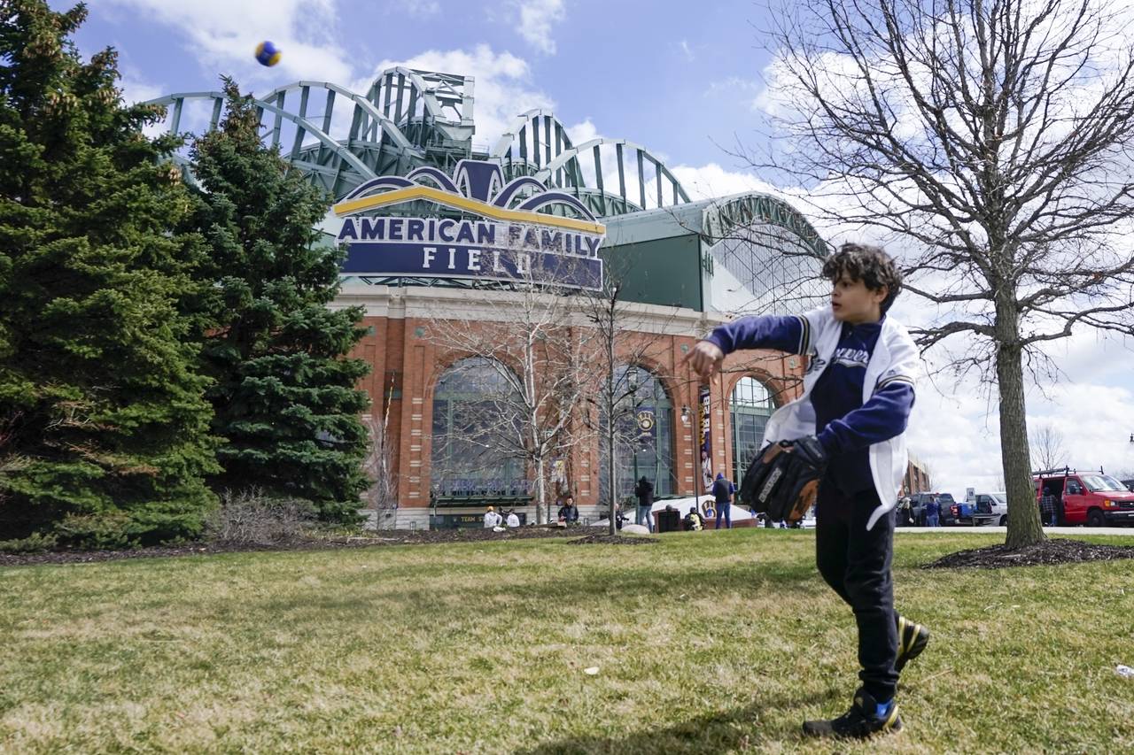 FILE - Lennon Jones plays catch outside American Family Field before the Milwaukee Brewers' home op...