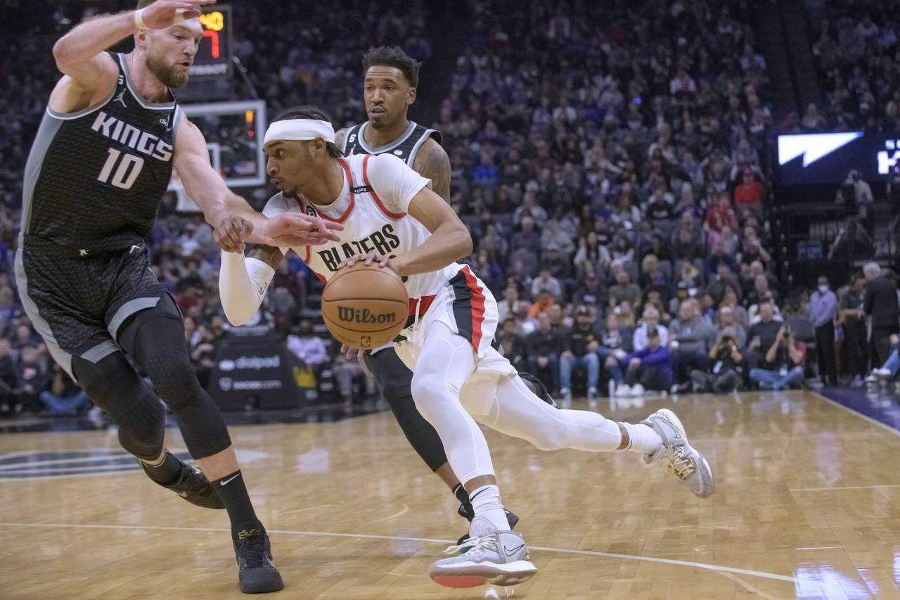 Portland Trail Blazers guard Keon Johnson drives to the basket past Sacramento Kings forward Domant...