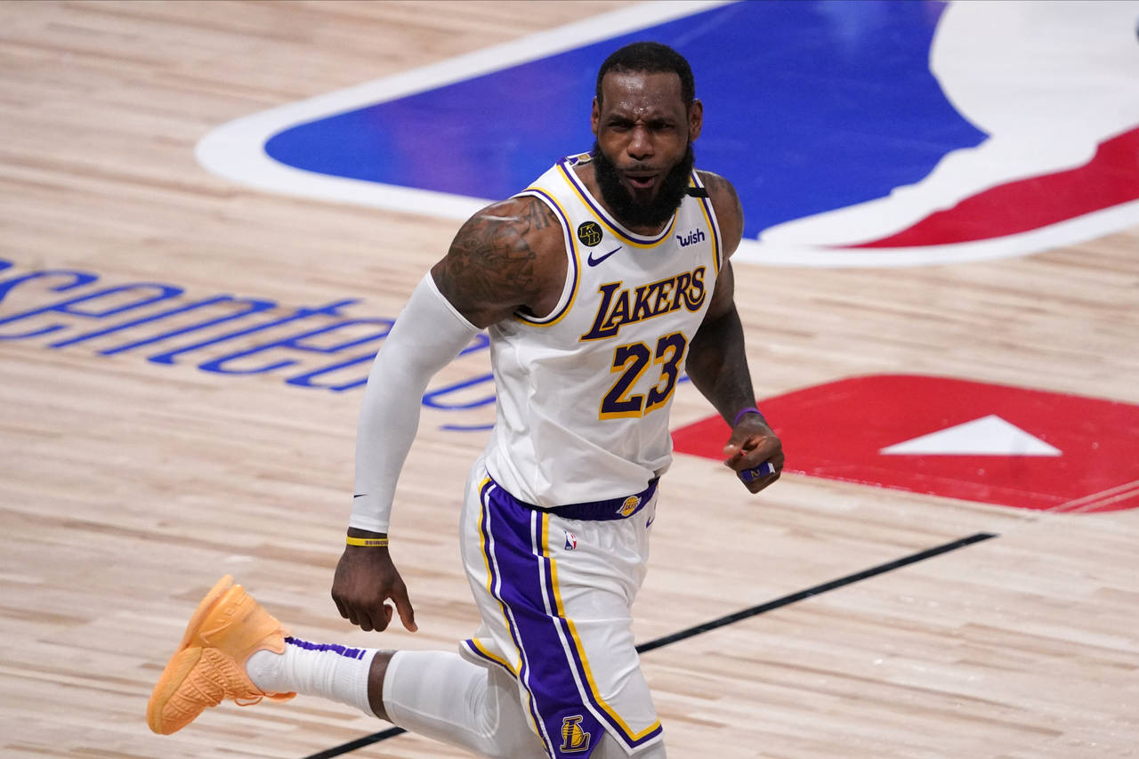 FILE -Los Angeles Lakers' LeBron James (23) celebrates during the second half in Game 6 of basketba...