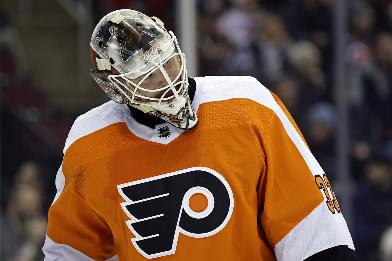 Philadelphia Flyers goaltender Samuel Ersson reacts during the second period of an NHL hockey game ...