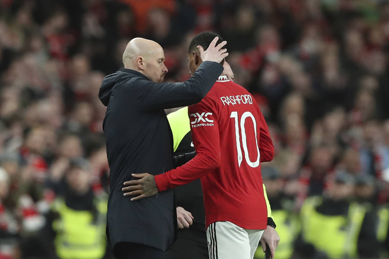 Manchester United's head coach Erik ten Hag, left, greets his player Marcus Rashford as he is subst...